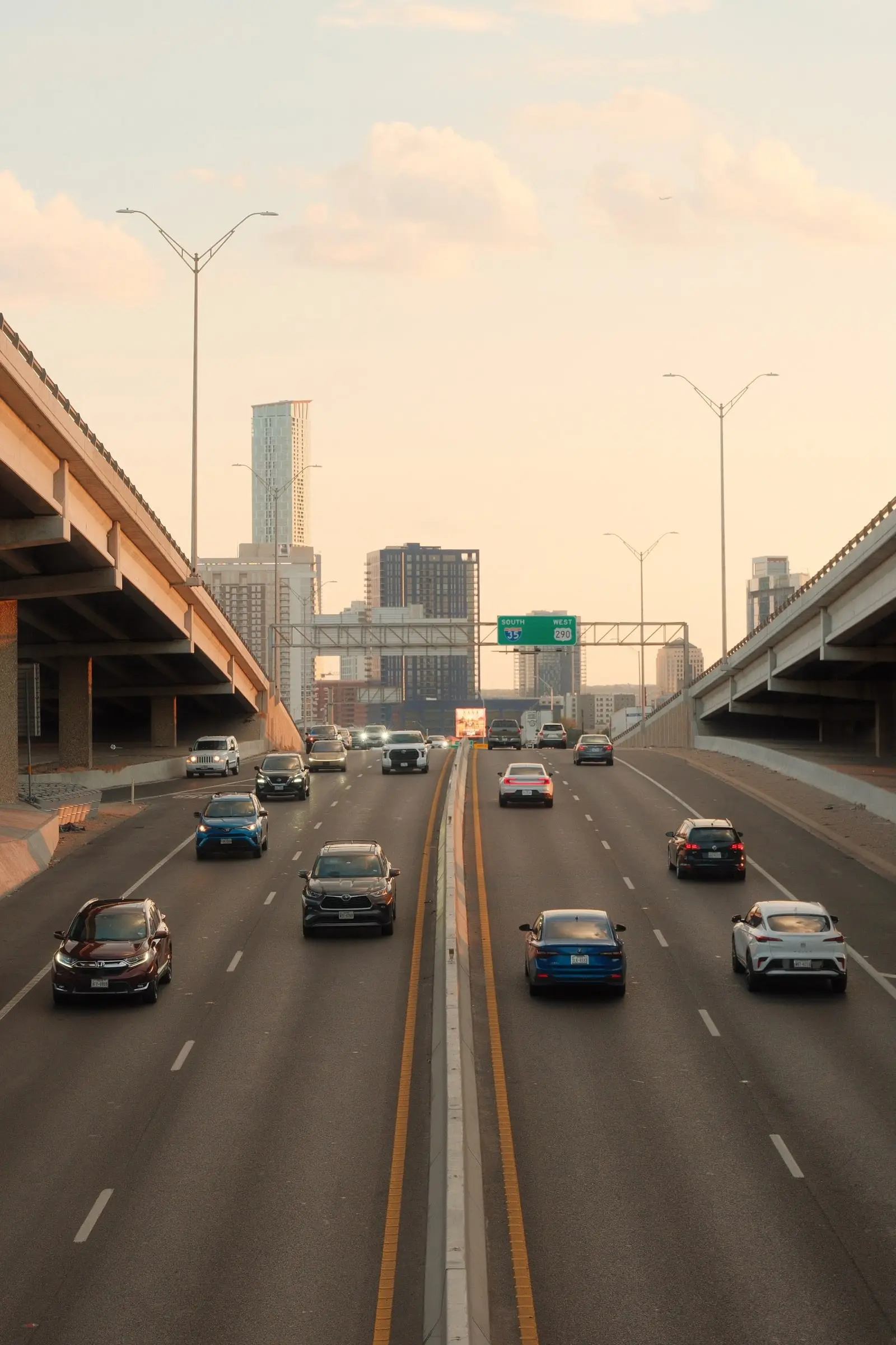 Highway traffic heading toward downtown at dusk — Austin