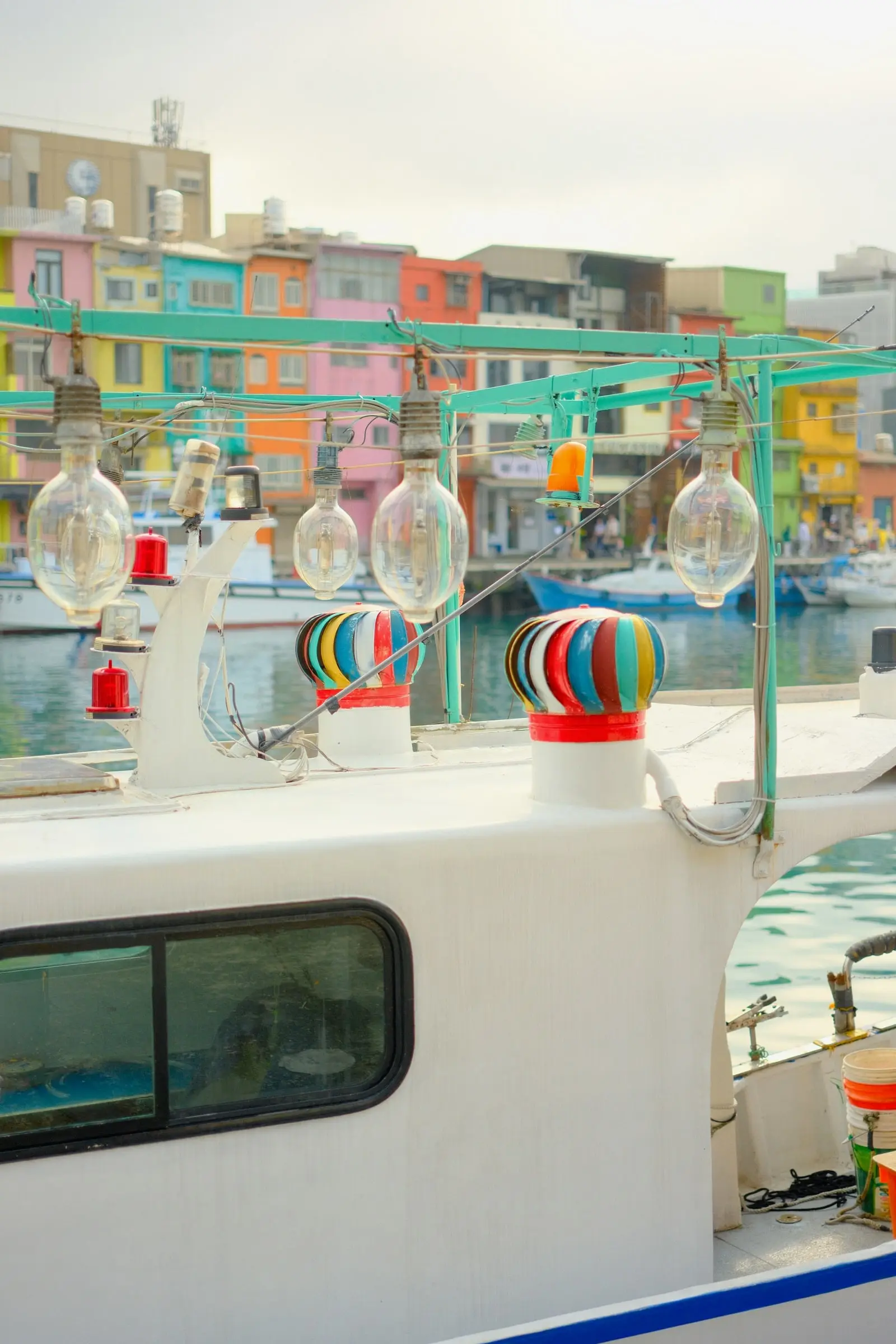Lamps on a fishing boat in front of colorful houses — Zhengbin Fishing Harbor, Keelung