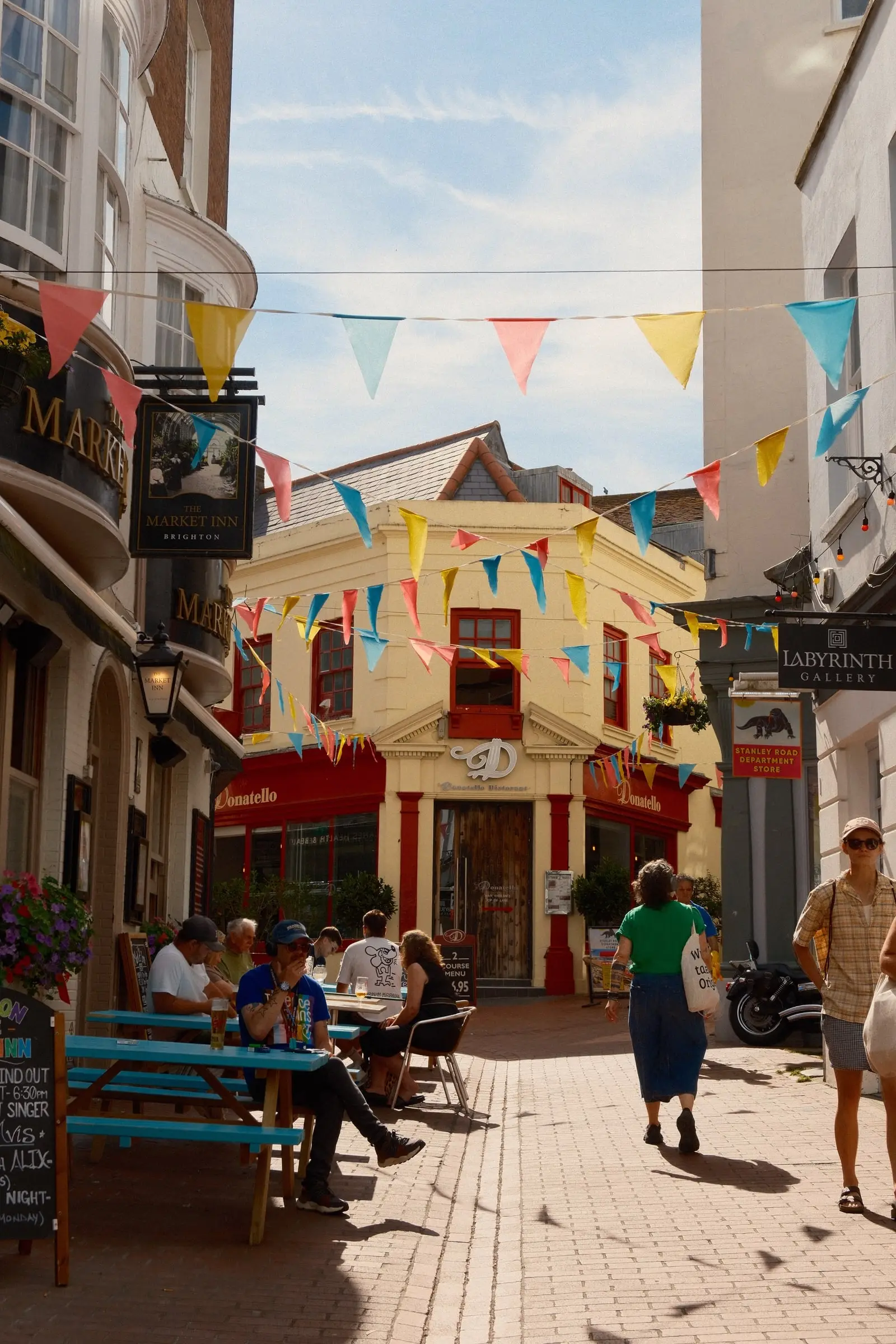 A pedestrian street strung with colorful bunting — Brighton